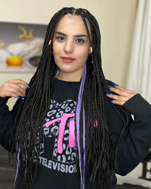 Isparta'da siyah örgü arasına mor tutamlar ve altın boncuk yerleştirilmiş knotless braids